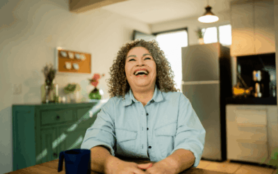 Woman at home smiling and looking up.
